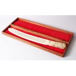 A LARGE 19TH CENTURY BURMESE CARVED IVORY PAGE TURNER WITH ORIGINAL BOX, the handle of the ivory