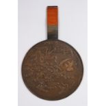 A GOOD JAPANESE MEIJI PERIOD BRONZE MIRROR, decorated with cranes flying amongst native flora,