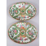 A PAIR OF 19TH CENTURY CHINESE CANTON FAMILLE ROSE OVAL PORCELAIN DISHES, both decorated with panels