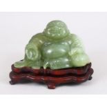 A 19TH / 20TH CENTURY CHINESE CARVED JADE FIGURE OF BUDDHA, in a seated position with a smile on his