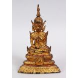 A SMALL TIBETAN GILT BRONZE FIGURE OF A BUDDHA / DEITY, in a seated position in meditation, the