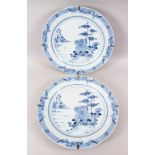 A LARGE PAIR OF 18TH CENTURY CHINESE QIANLONG BLUE & WHITE CHARGERS, decorated with scenes of native