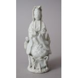 AN EARLY 19TH CENTURY CHINESE DEHUA / BLANC DE CHINE FIGURE OF GUANYIN, stood upon a floral base