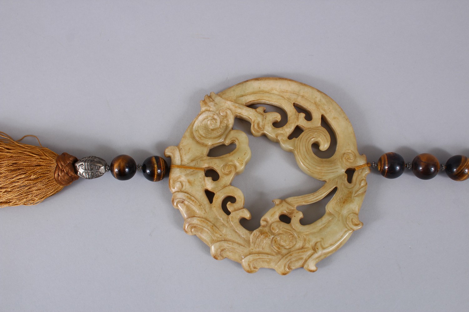 A GOOD 19TH / 20TH CENTURY CHINESE CARVED NEPHRITE HARDSTONE ROUNDEL WITH TIGER EYE BEADS, the - Image 2 of 4