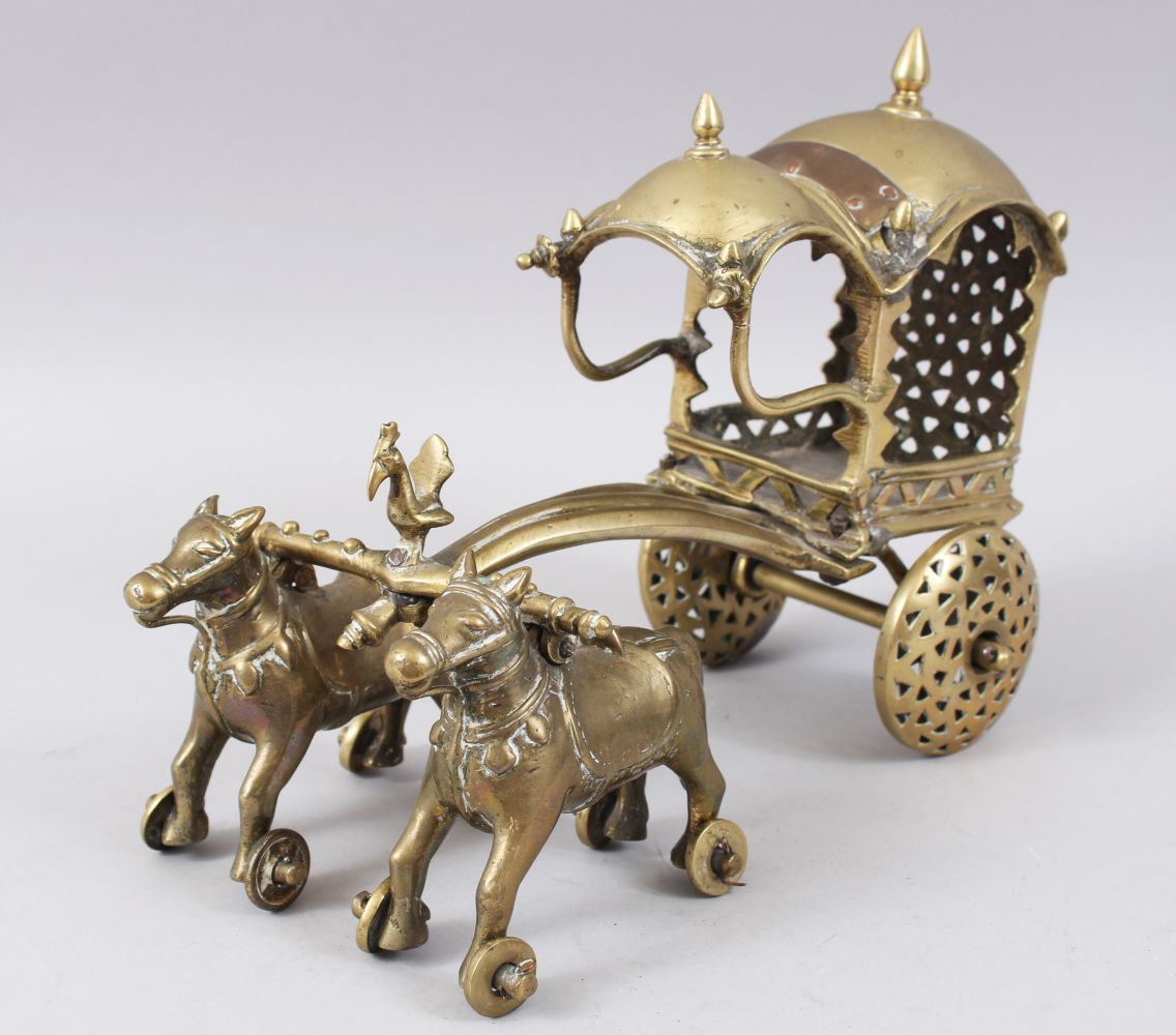 AN 18TH-19TH CENTURY INDIAN BRASS CHILDS TOY CHARIOT being pulled by two horses, 27cm long.