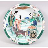 A CHINESE KANGXI STYLE FAMILLE VERT PORCELAIN DISH, the dish decorated with scenes of figures within