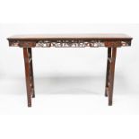 A LARGE 19TH CENTURY CHINESE HARDWOOD ALTER TABLE, the frieze carved to depict cherry blossom, stood