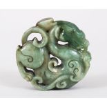 A GOOD 19TH / 20TH CENTURY CHINESE CARVED JADE DRAGON ROUNDEL / PENDANT, 5.5cm diameter.