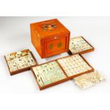 A GOOD 20TH CENTURY CHINESE MAHJONG GAMES BOX WITH ITS BONE PIECES, the front with a removable panel