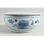 A GOOD CHINESE TRANSITIONAL BLUE AND WHITE BOWL, the sides decorated with flowers. 10ins diameter.