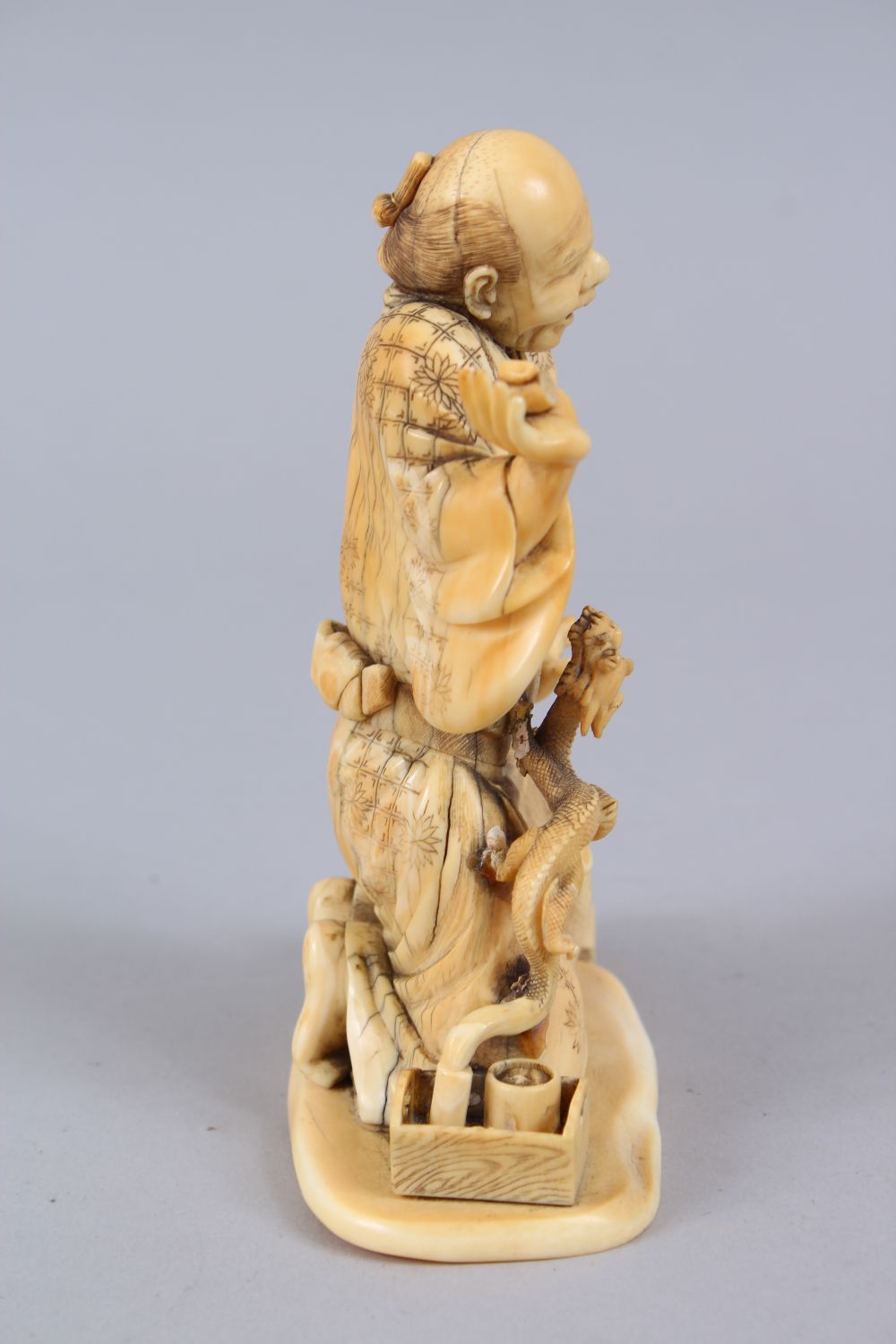 A JAPANESE MEIJI PERIOD CARVED IVORY OKIMONO OF AN ARHAT & DRAGON, the elder on his knees with his - Image 2 of 8