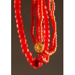 TWO GOOD CHINESE CORAL LIKE BEAD NECKLACES, one with a gold coloured circular clasp, 100cm open &