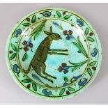 A 17TH CENTURY OTTOMAN IZNIK CERAMIC DEER DISH, the green / blue ground with floral decoration and a