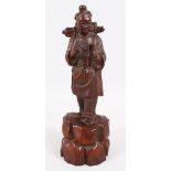 A GOOD JAPANESE MEIJI PERIOD CARVED HARDWOOD FIGURE OF A MAN, stood upon a realistically carved