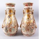 A GOOD PAIR OF JAPANESE MEIJI PERIOD MOULDED SATSUMA VASES, the body of the vases decorated in