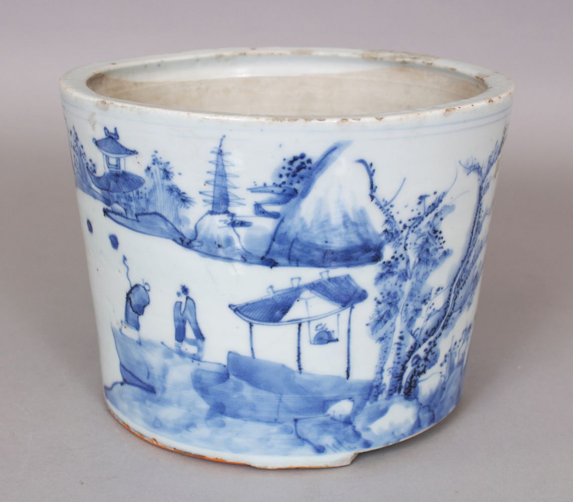 A CHINESE BLUE & WHITE PORCELAIN BRUSHPOT, the flaring sides painted with a continuous river