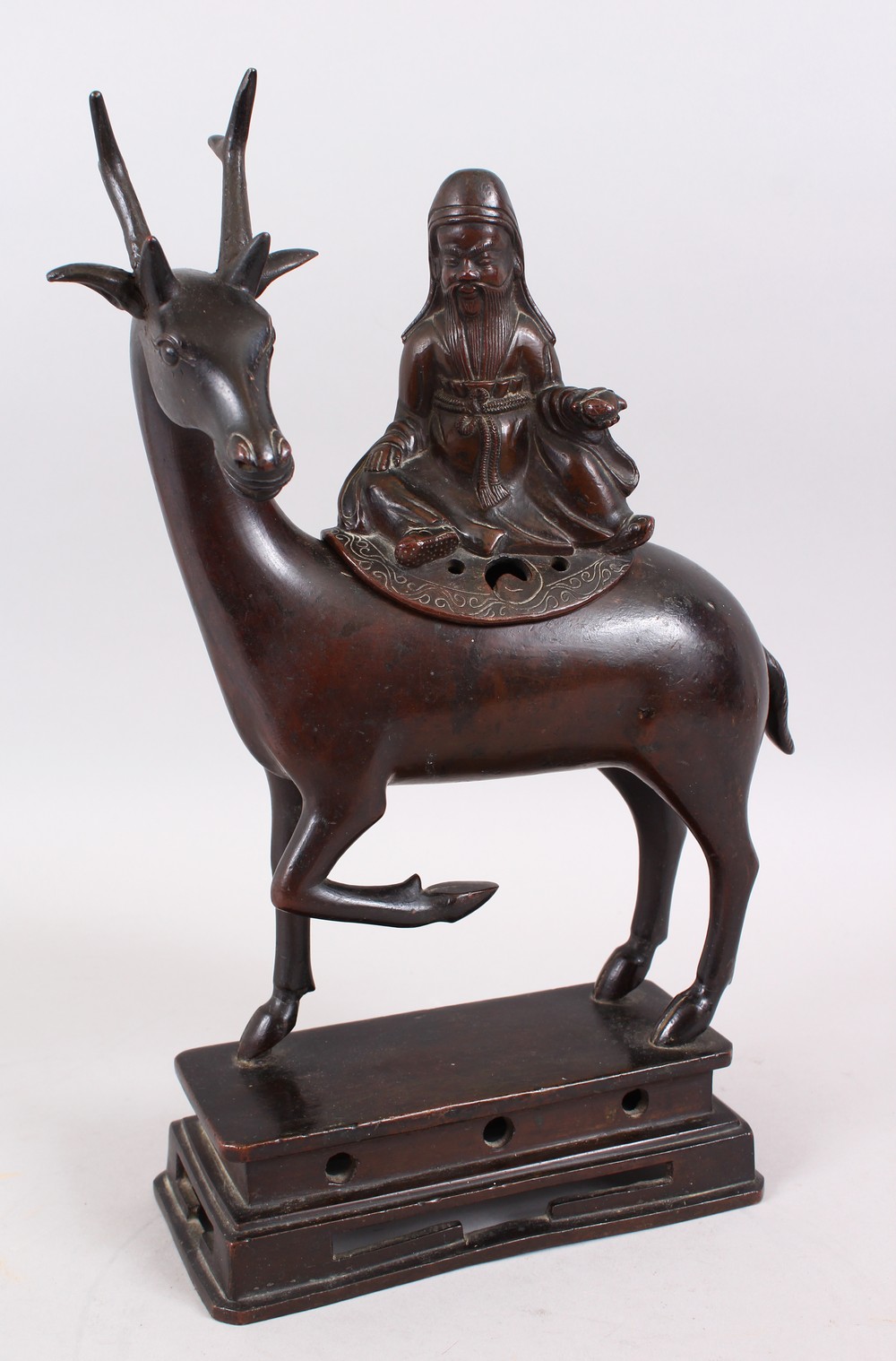 A 19TH CENTURY CHINESE BRONZE CENSER / BURNER OF A DEER, the deer in a gentle pose with one hoof