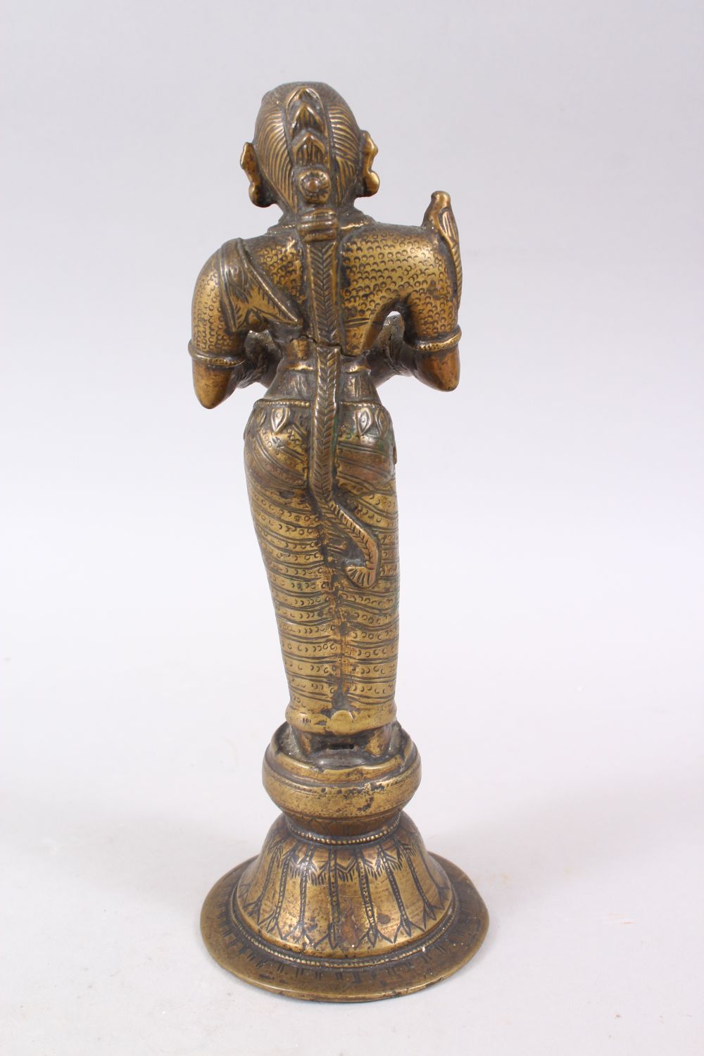 AN 18TH CENTURY INDIAN BRONZE OIL LAMP FIGURE OF LAKSHMI, stood on plinth holding a dish, 27cm - Image 3 of 6