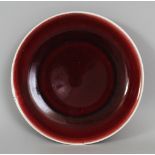 A CHINESE COPPER RED PORCELAIN DISH, the base with a six-character mark, 23.3cm diameter.