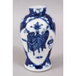 A SMALL 19TH CENTURY CHINESE BLUE & WHITE PRUNUS VASE, the body with panels of precious objects,