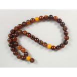 A 19TH CENTURY QING DYNASTY CHINESE RHINOCEROS HORN & AMBER ROSARY BEADS / NECKLACE, comprising of