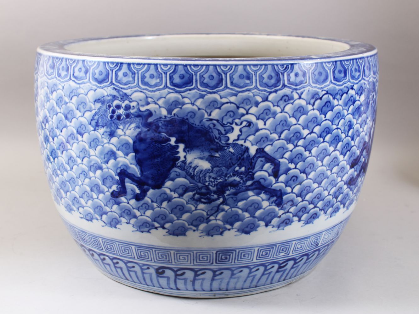 A GOOD JAPANESE MEIJI PERIOD BLUE & WHITE ARITA PORCELAIN JARDINIERE, decorated with scenes of