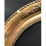 19th Century French School. An Oval Gilt Composition Frame, 18" x 15".