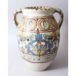 A LARGE NORTH AFRICAN POTTERY TWIN HANDLED VASE, 31.5cm high x 24. wide.