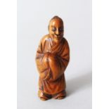 A JAPANESE MEIJI PERIOD CARVED WOODEN NETSUKE OF A CHINESE LITERATUS, stood holding his hands