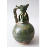 AN EARLY OMAYAD GREEN GLAZED POTTERY EWER, 21cm high.