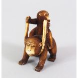 A JAPANESE MEIJI PERIOD CARVED IVORY NETSUKE OF TWO MONKEYS, the young monkey riding upon the back