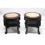 A GOOD PAIR OF LARGE 19TH CENTURY CHINESE CARVED HARDWOOD MARBLE TOP STANDS, each stand inset with
