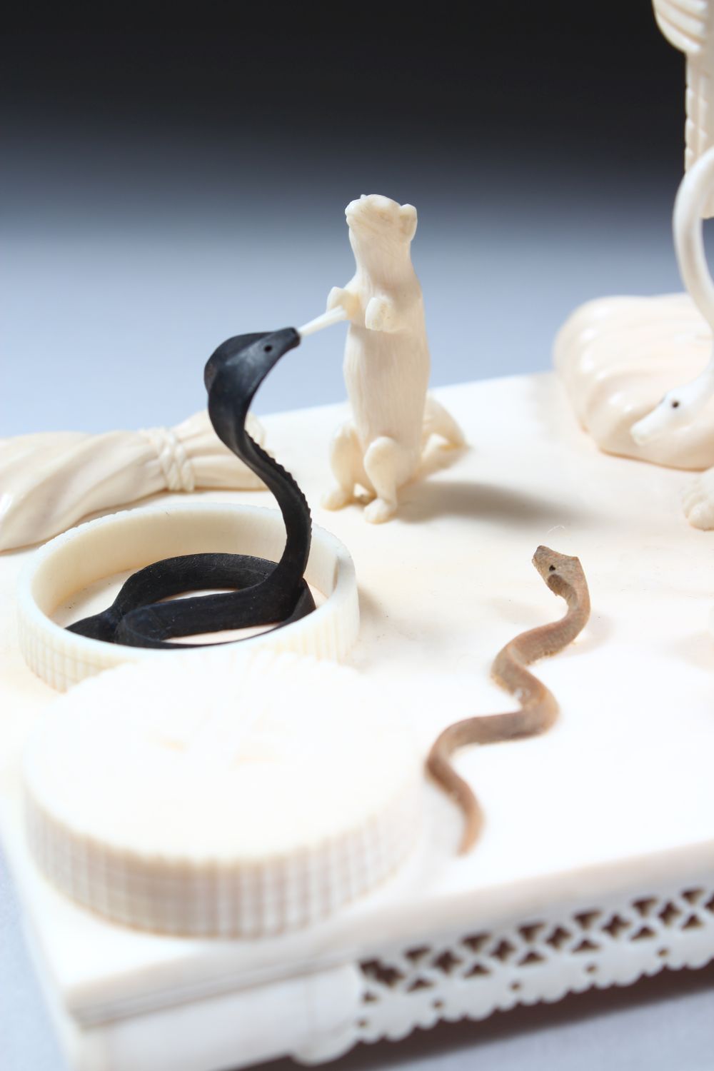 A 19TH CENTURY CARVED INDIAN IVORY MODEL OF A SNAKE CHARMER, the man stood over two snakes with a - Image 7 of 8