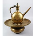 AN 18TH CENTURY MUGHAL INDIAN BRASS EWER & BASIN, the ewer 27cm high x 26cm wide. the basin 15cm