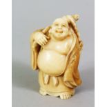 A JAPANESE MEIJI PERIOD CARVED IVORY OKIMONO OF HOTEI, stood with his lucky sac over his shoulder