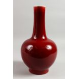 A 19TH CENTURY CHINESE SANG DE BOEUF BOTTLE VASE. 13ins high.