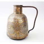 A LATE 19TH CENTURY ISLAMIC DAMASCUS BRASS PITCHER, inlaid in silver and copper, with calligraphy,