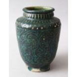 AN EARLY KASHAN POTTERY VASE, with incised black and turquoise glaze decoration, 17cm high.