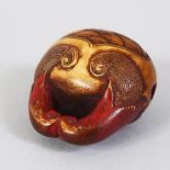 A JAPANESE EARLY MEIJI PERIOD CARVED STAG ANTLER NETSUKE OF A MOKUGYO, carved and stained, himotoshi