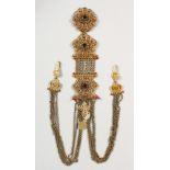 AN INDIAN GILT METAL FILIGREE CHATTLEANE, mounted with semi precious stones, coins and crucifix,