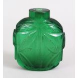 A 19TH / 20TH CENTURY CHINESE PEKING GREEN GLASS SNUFF BOTTLE, With carved decoration of foliage,