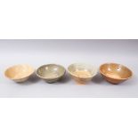 FOUR EARLY CHINESE POTTERY GLAZED BOWLS, some glazed, some partially glazed, various sized but