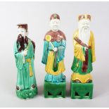 THREE 20TH CENTURY CHINESE SANCAI GLAZED PORCELAIN FIGURES OF SCHOLARS, each modeled upon a