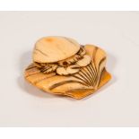 A JAPANESE EDO PERIOD CARVED IVORY NETSUKE OF CRAB & SHELLS, the crab upon the shell, the crabs eyes