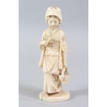 A JAPANESE MEIJI PERIOD CARVED IVORY OKIMONO OF A GEISHA, the lady stood holding a basket of flora