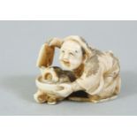 A JAPANESE MEIJI PERIOD CARVED IVORY NETSUKE OF SHELL COLLECTOR, the man crouched over his pan of