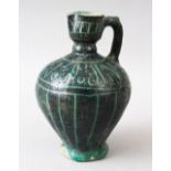 AN EARLY KASHAN POTTERY JUG, painted dark green, 18cm high.