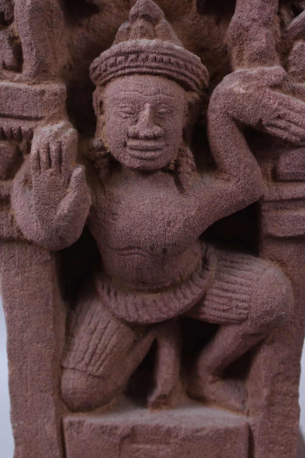 A CAMBODIAN KHMER STYLE CARVING OF A CROUCHING FIGURE IN A TEMPLE. - Image 3 of 6