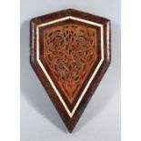 A SMALL CARVED WOOD MAMLUK FRAGMENT, with bone inlay, 16.5cm long.
