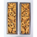 A PAIR OF 20TH CENTURY CHINESE CARVED GILT WOOD PANELS, carved with floral design, 45cm x 15cm.
